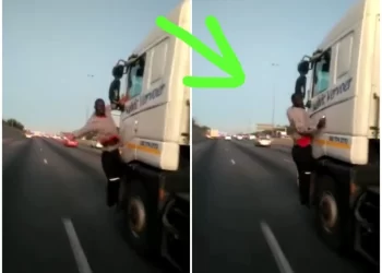 WATCH: Man caught on camera hanging from a moving truck on the highway. How did he get there?