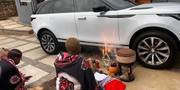 People congratulating Gogo Maweni after she bought a new car. See this