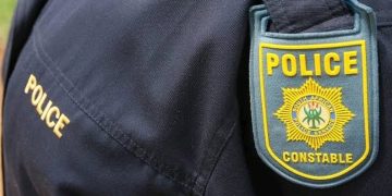 A female police officer pumped four bullets into her husband after he allegedly pulled a gun on her